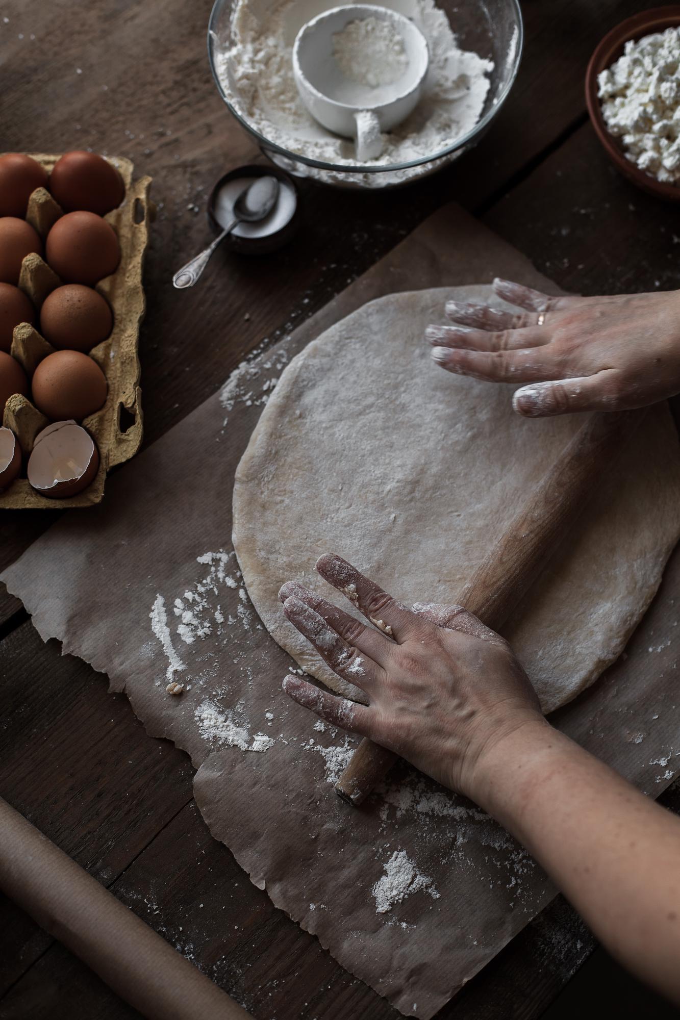 Hands kneading dough in warm kitchen light